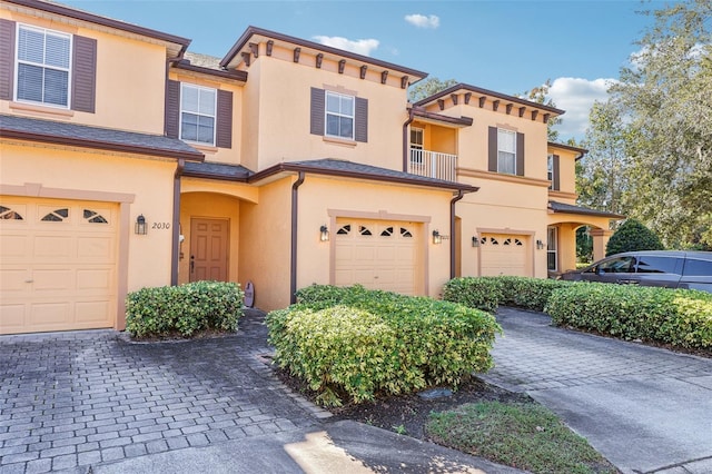 multi unit property featuring a garage