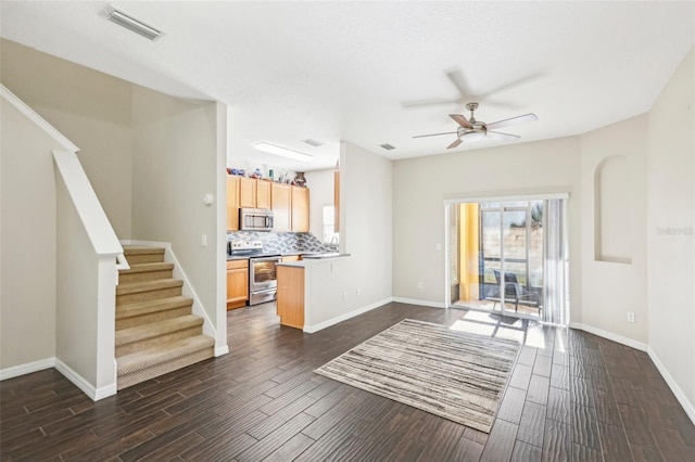 living room with ceiling fan and dark hardwood / wood-style flooring