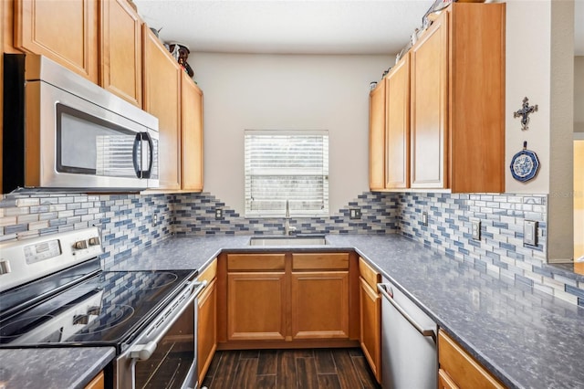 kitchen featuring appliances with stainless steel finishes, tasteful backsplash, and sink