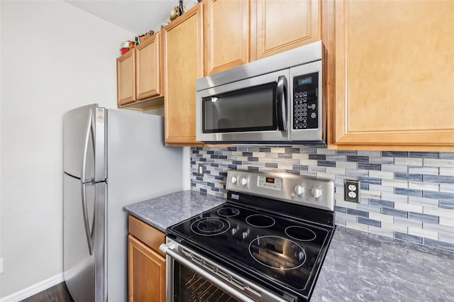 kitchen with stainless steel appliances and tasteful backsplash