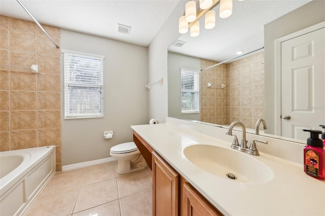 full bathroom with tile patterned floors, vanity, a textured ceiling, tiled shower / bath combo, and toilet