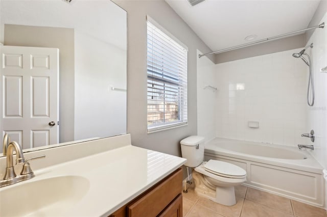 full bathroom featuring toilet, vanity, tile patterned floors, and tiled shower / bath