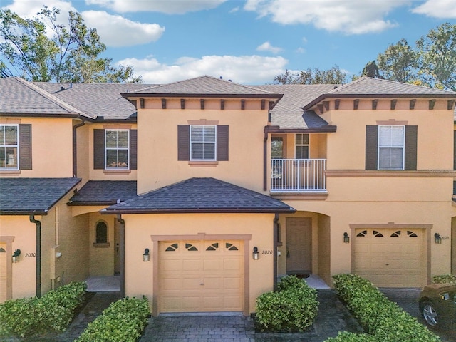 view of front of property with a balcony and a garage