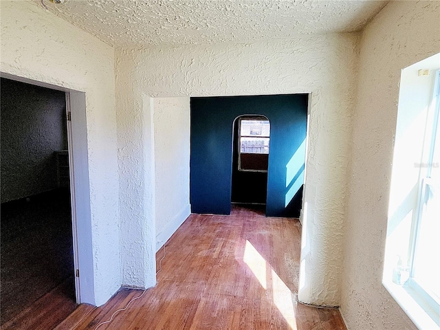 corridor with hardwood / wood-style floors