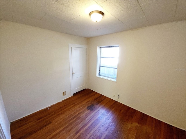 unfurnished room featuring dark hardwood / wood-style flooring