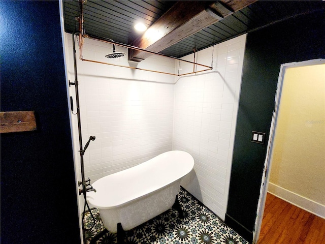 bathroom with hardwood / wood-style flooring, a washtub, wood ceiling, and beamed ceiling