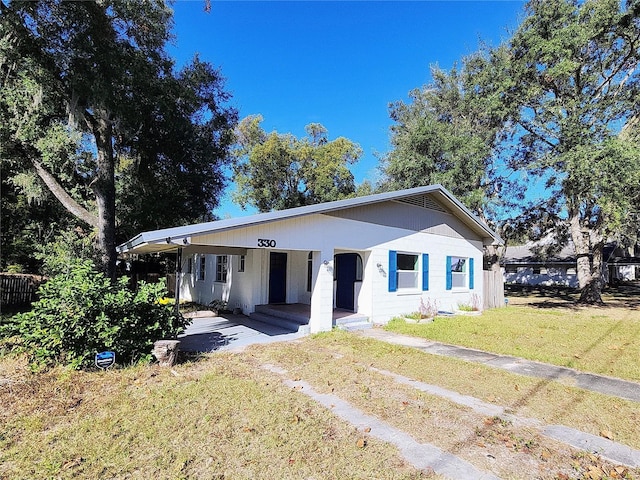 bungalow-style home with covered porch and a front lawn