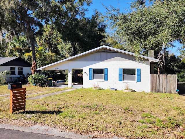 view of front of property with a front yard and a carport