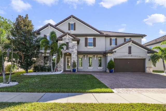 view of front of property featuring a garage and a front lawn