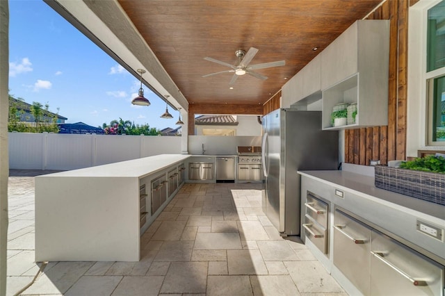 view of patio / terrace featuring ceiling fan, a mountain view, and exterior kitchen