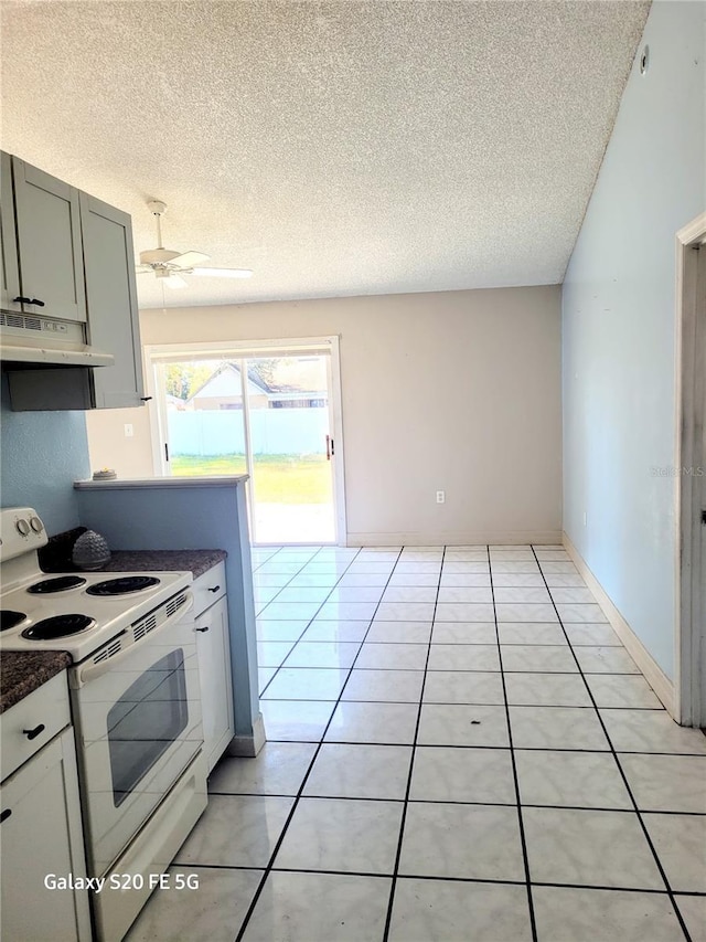 kitchen featuring white electric range oven, light tile patterned floors, a textured ceiling, and ceiling fan