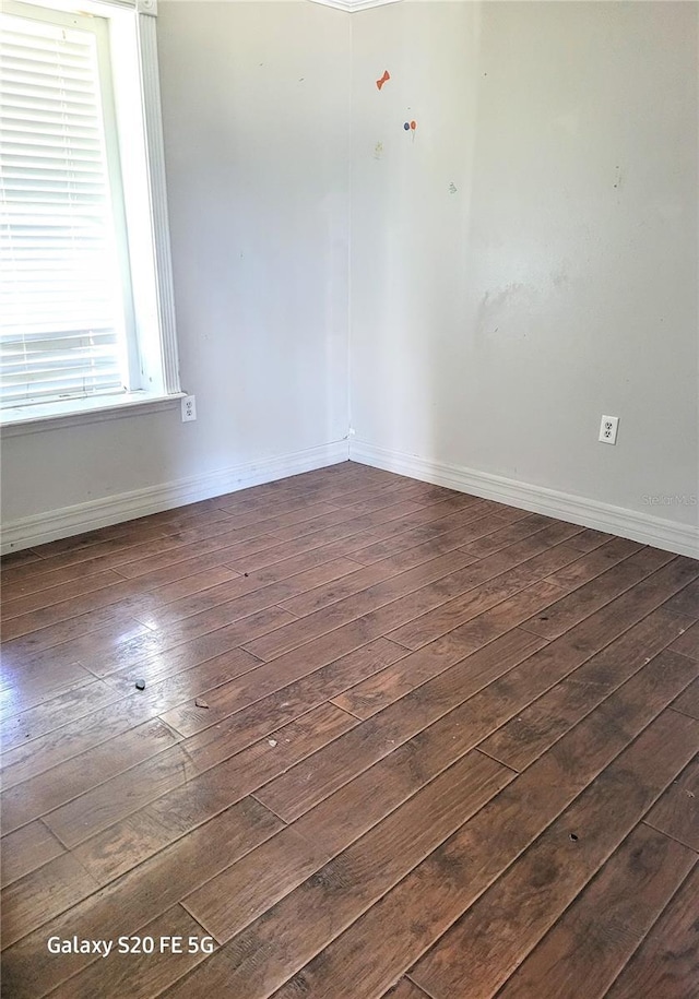 spare room with dark hardwood / wood-style floors