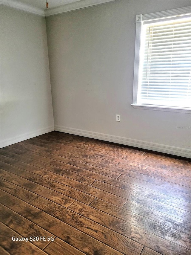 unfurnished room with dark hardwood / wood-style flooring