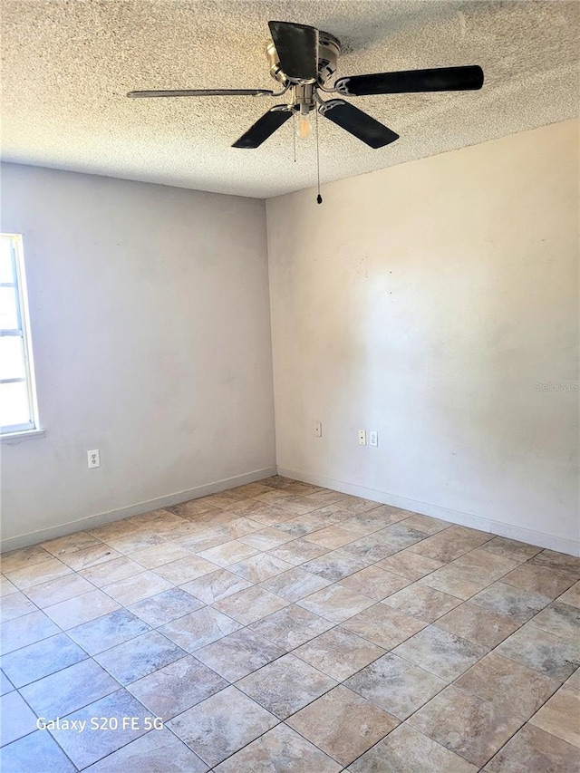 spare room with ceiling fan and a textured ceiling