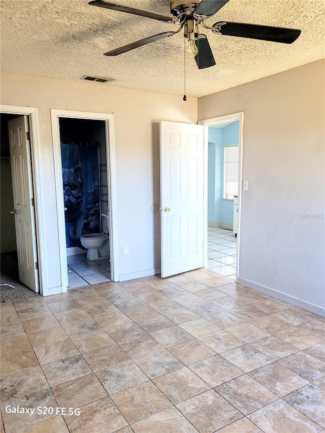 unfurnished bedroom with connected bathroom, ceiling fan, and a textured ceiling