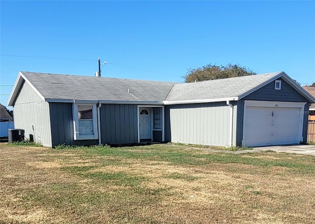 single story home featuring a front lawn, central AC unit, and a garage