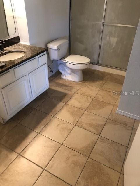 bathroom with vanity, toilet, and an enclosed shower