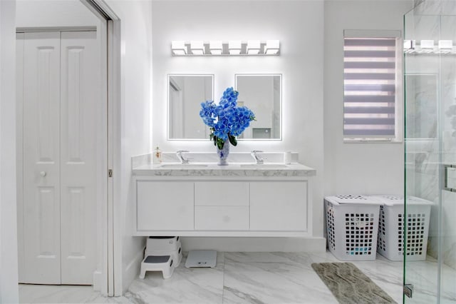 bathroom featuring vanity and a shower with door