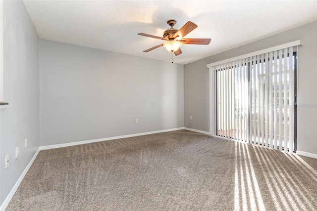 spare room with a textured ceiling, carpet floors, and ceiling fan