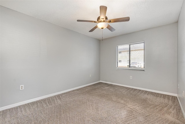 spare room with carpet flooring, a textured ceiling, and ceiling fan