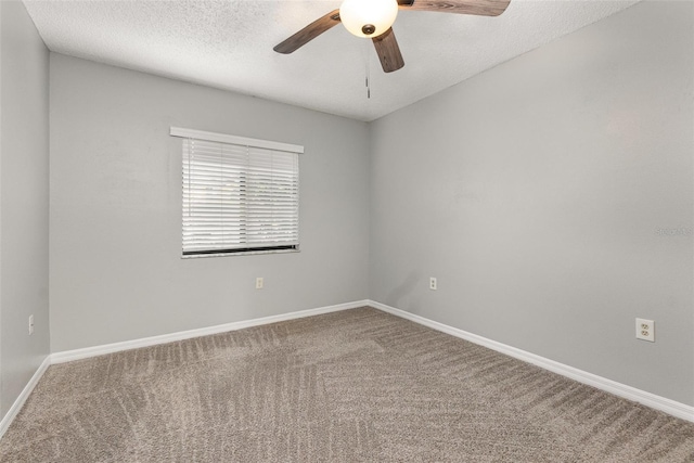 carpeted spare room with ceiling fan and a textured ceiling