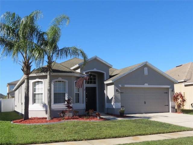 view of front facade with a front yard and a garage