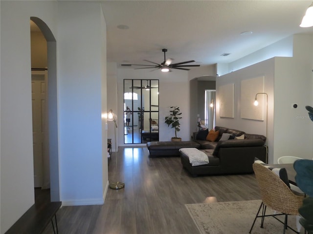 living room with ceiling fan, french doors, and dark hardwood / wood-style floors