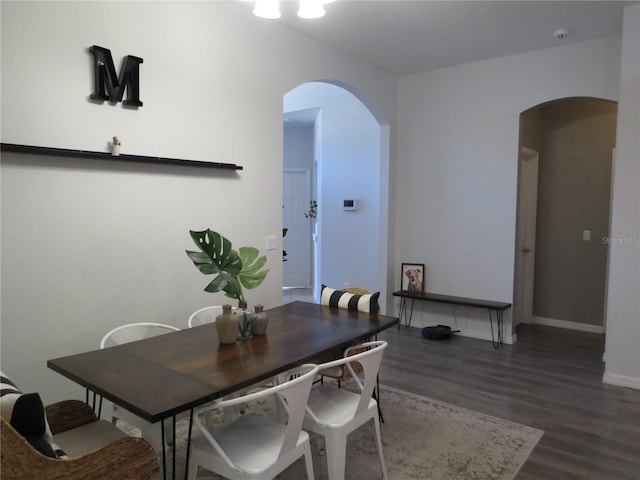 dining room with dark hardwood / wood-style flooring