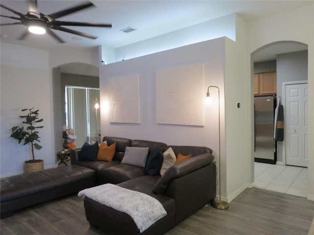 living room featuring ceiling fan and wood-type flooring