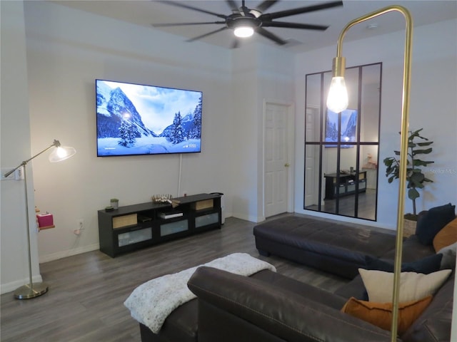 living room featuring ceiling fan and dark hardwood / wood-style flooring