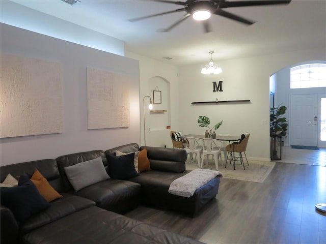 living room featuring hardwood / wood-style flooring and ceiling fan with notable chandelier