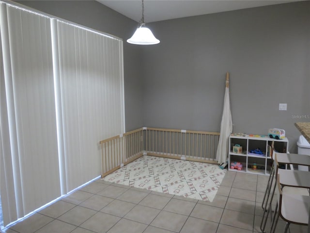 unfurnished dining area featuring light tile patterned floors