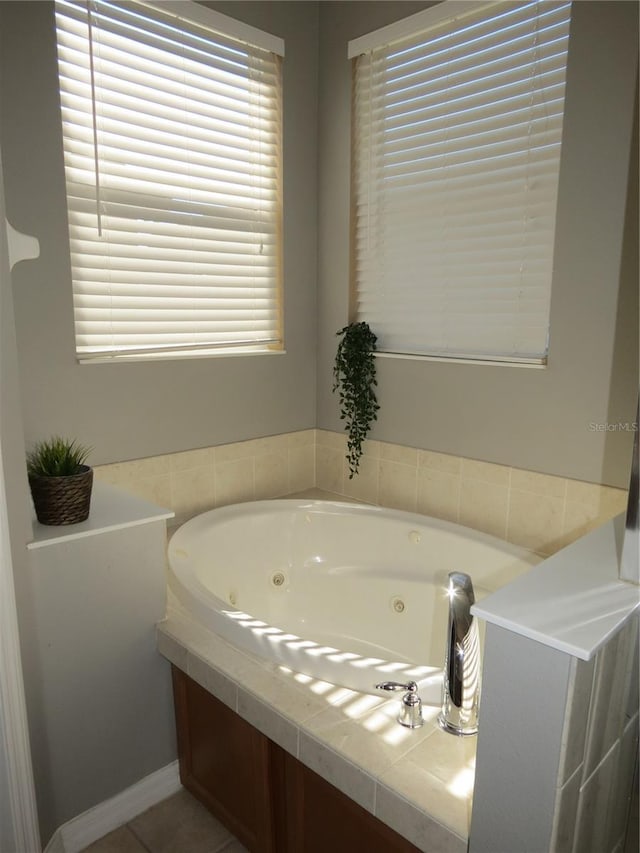 bathroom featuring a tub to relax in and plenty of natural light