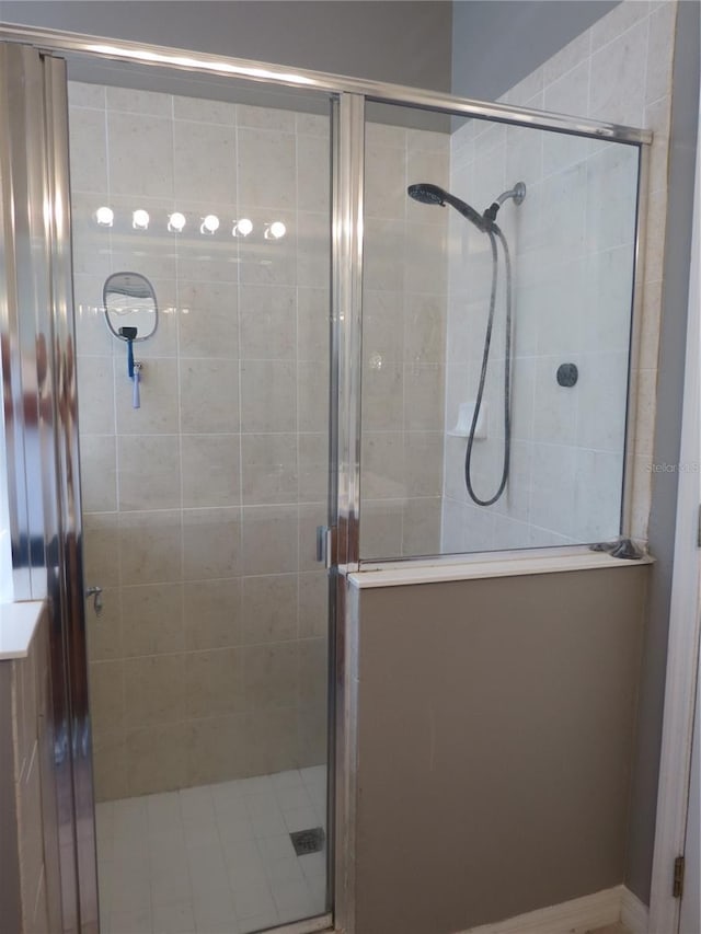 bathroom with a shower with door