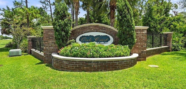 community / neighborhood sign featuring a yard