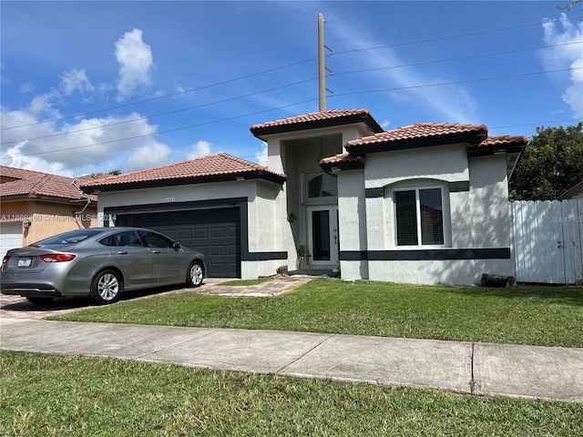 mediterranean / spanish-style house featuring a garage and a front yard