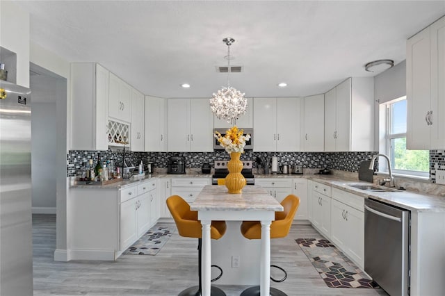 kitchen featuring a center island, white cabinetry, and appliances with stainless steel finishes