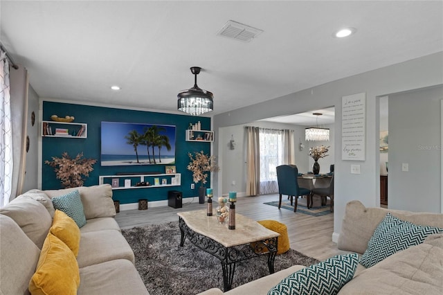 living room with hardwood / wood-style floors and a chandelier