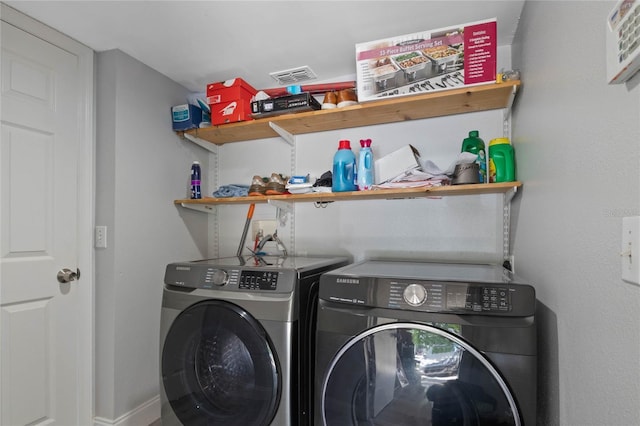 clothes washing area with washing machine and clothes dryer