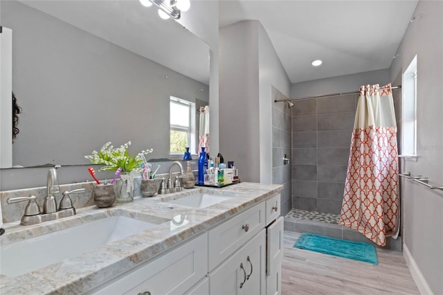 bathroom featuring hardwood / wood-style floors, vanity, and walk in shower