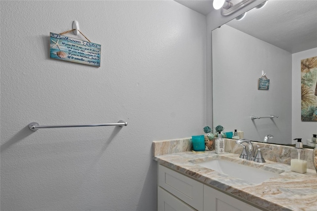 bathroom with vanity and a textured ceiling