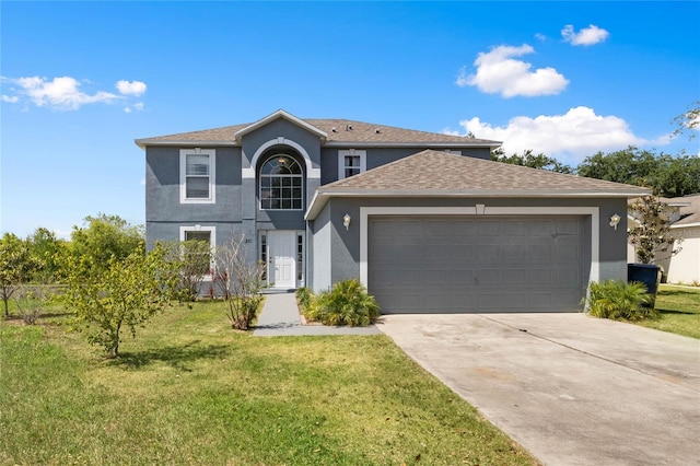 view of property featuring a garage and a front yard