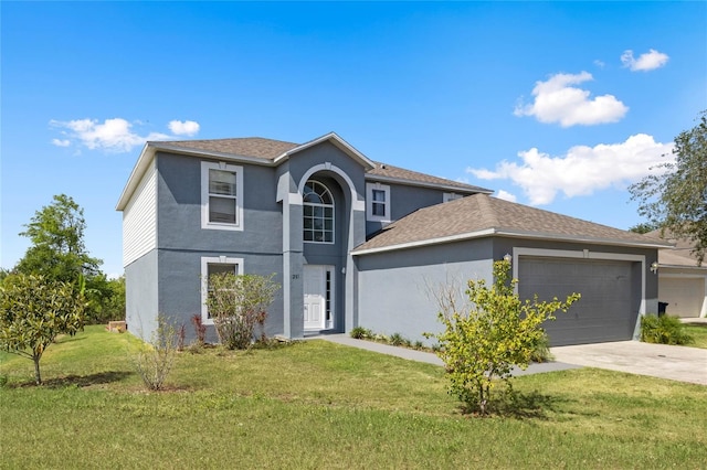 view of front property with a garage and a front yard