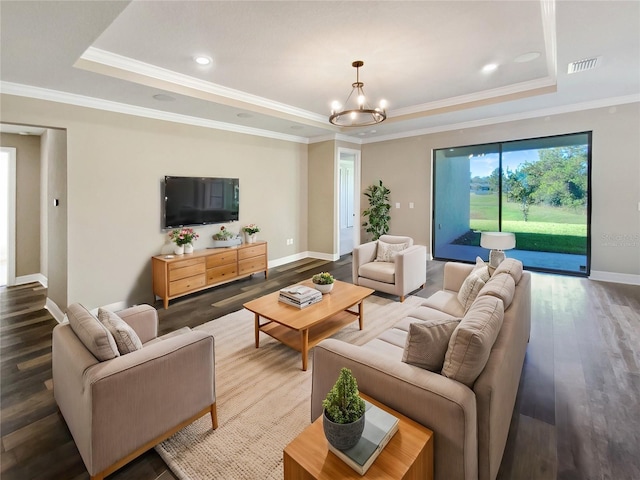 living room featuring wood-type flooring, a raised ceiling, and ornamental molding