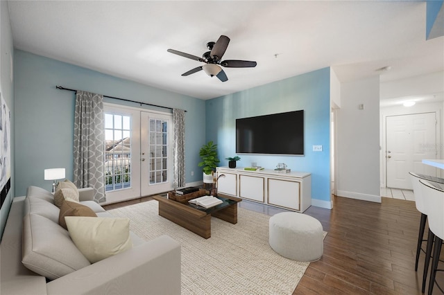 living room featuring ceiling fan, french doors, and wood-type flooring