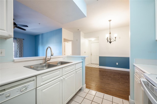 kitchen with dishwasher, white cabinets, ceiling fan with notable chandelier, sink, and light hardwood / wood-style flooring