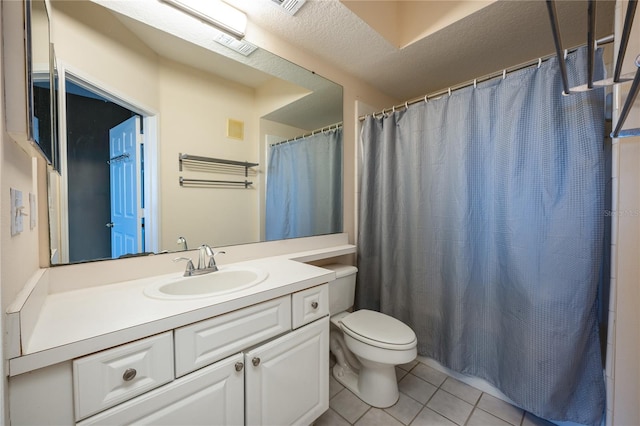 bathroom with vanity, tile patterned floors, toilet, a textured ceiling, and curtained shower