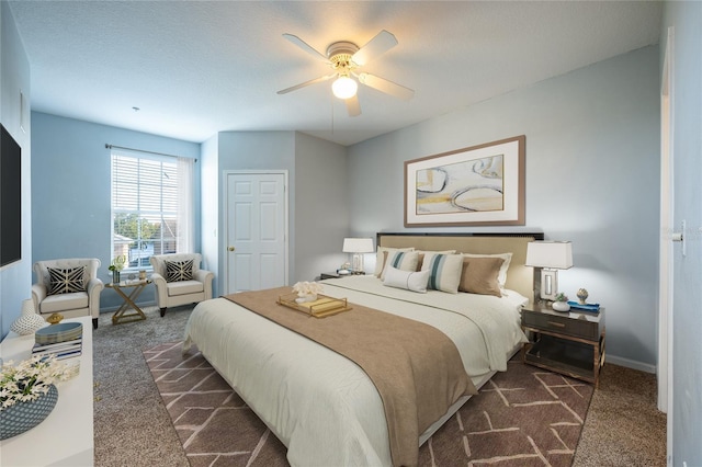 carpeted bedroom with a textured ceiling and ceiling fan