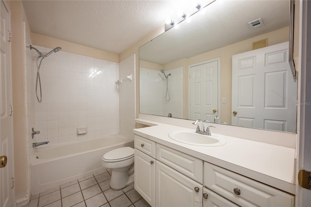 full bathroom with tile patterned floors, a textured ceiling, toilet, vanity, and tiled shower / bath