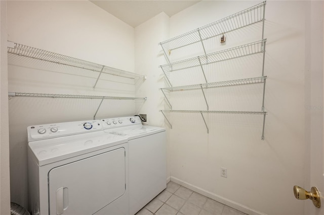 clothes washing area with separate washer and dryer